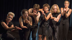 Days-Like-These-performers-all-lined-up,-dressed-in-black,-each-of-them-with-hands-out-infront,-trying-to-explain-something,-appearing-to-be-frustrated Days-Like-These-performers-all-lined-up,-dressed-in-black,-each-of-them-with-hands-out-infront,-trying-to-explain-something,-appearing-to-be-frustrated