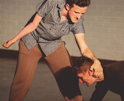 Bowerbirds sharing. Dan on his hands & knees on the ground, Daniel standing over him, gripping Dans next with his hand, angry and upset Bowerbirds sharing. Dan on his hands & knees on the ground, Daniel standing over him, gripping Dans next with his hand, angry and upset