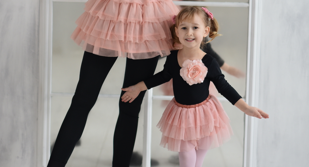 Mum and little girl in ballet clothes.